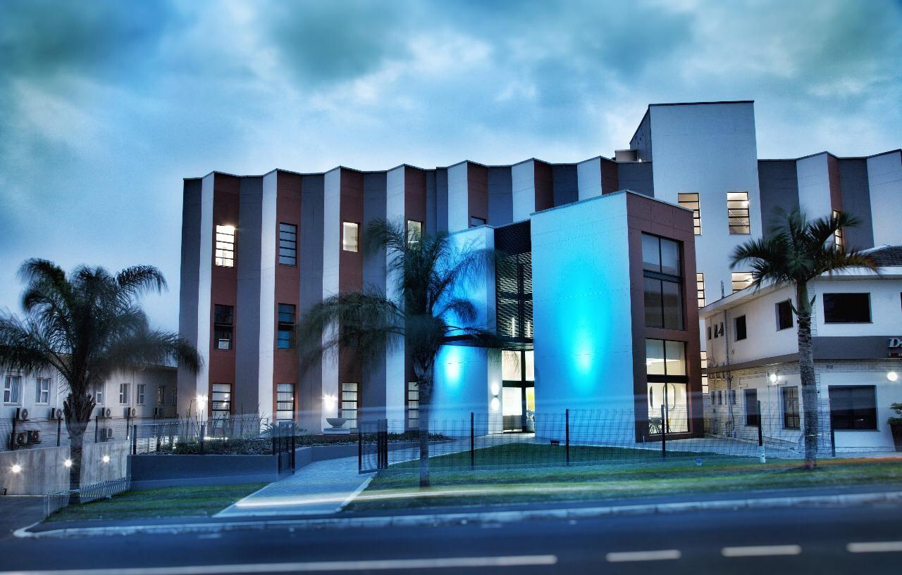 Hibiscus Hospital exterior lit up at dusk